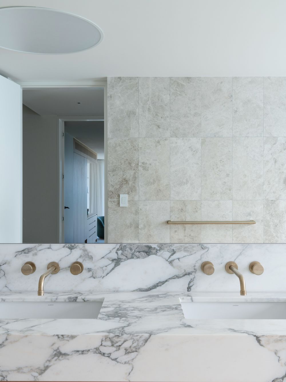 Calacatta marble vanity with brass wall taps at Terrigal