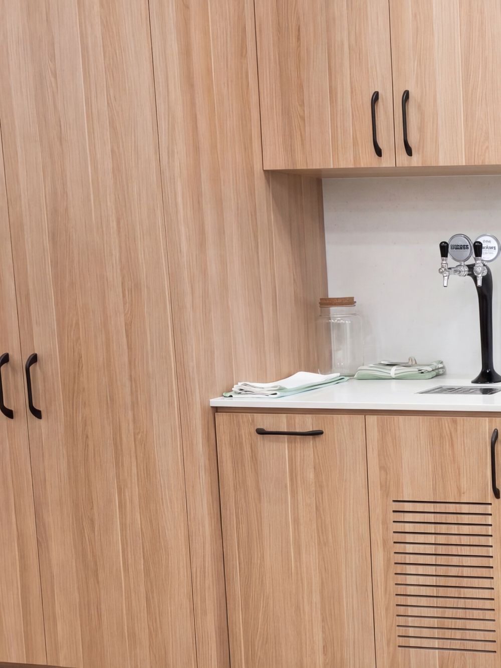 White kitchenette counter with timber joinery in a Newcastle office fitout