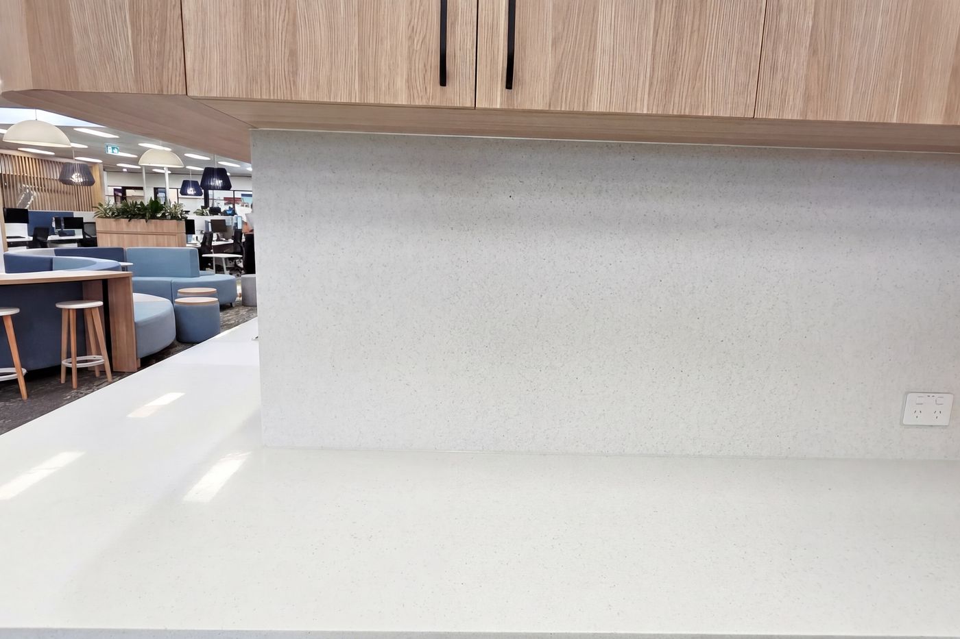 White stone kitchenette counter with timber cabinetry in a Newcastle office