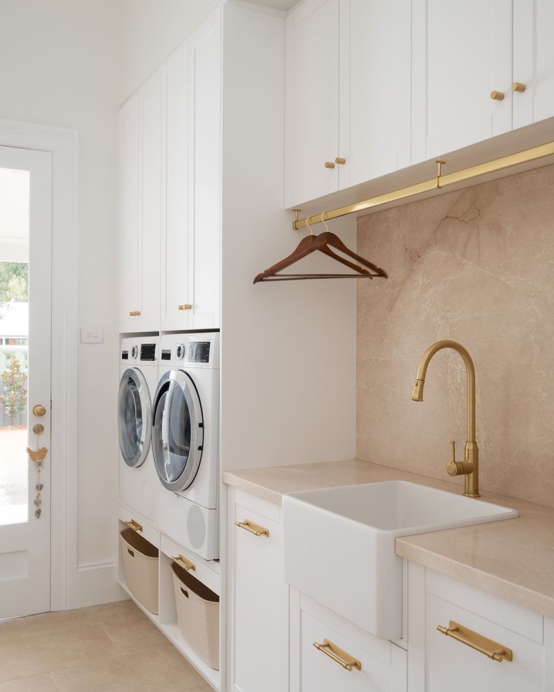 Laundry with a stone benchtop, splashback and farmhouse sink